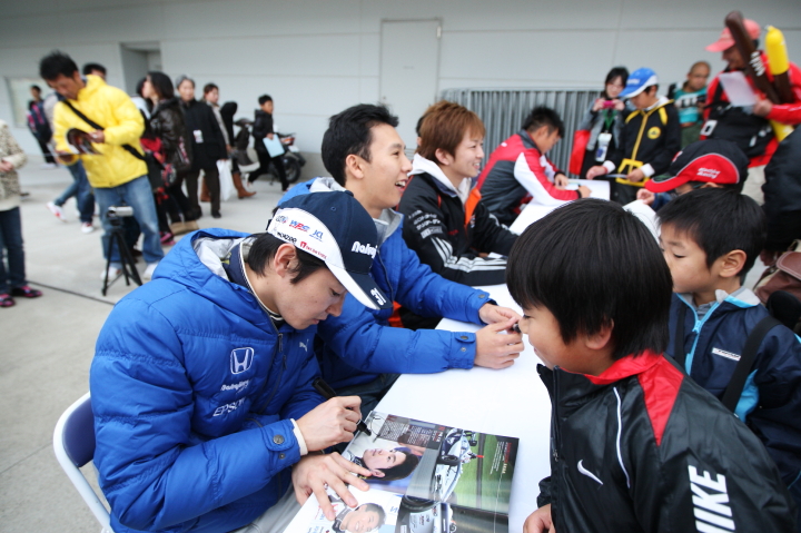 サインする中嶋大祐と小暮卓史のTEAM IMPULコンビ