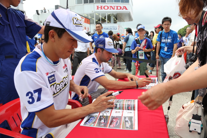 決勝日ピットウォーク: サインをする伊藤大輔とアンドレア・カルダレッリ（KeePer TOM'S SC430）